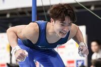男子個人総合　鉄棒で着地を決め、笑顔の岡慎之助