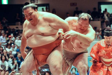 　御嶽海（左）と最後の一番を取った元小結北勝富士の大山親方＝３０日、両国国技館
