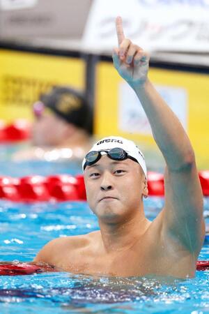 　男子５０メートル平泳ぎで優勝しポーズをとる谷口卓