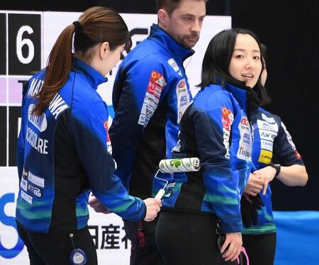 松沢弥子（左）が粘着ローラで藤沢五月の背中をクリーニングする＝２０２５年２月