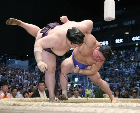 藤ノ川（右）がすくい投げで王鵬を破る