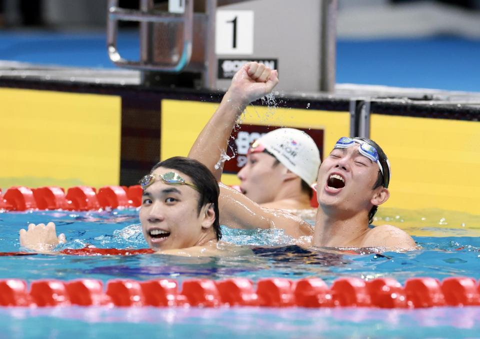 男子１００ｍバタフライ決勝を制し、ガッツポーズの光永翔音（左は松元克央）＝撮影・伊藤笙子