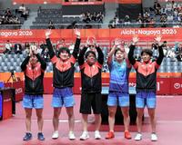 男子団体で金メダルを獲得し、歓声に応える日本の選手たち
