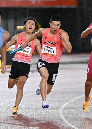 男子４００メートルリレー決勝　第２走者の小室歩久斗（左）からバトンを受ける第３走者の桐生祥秀　