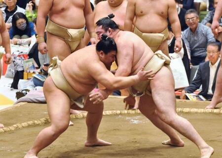 　朝稽古で相撲を取る義ノ富士（左）