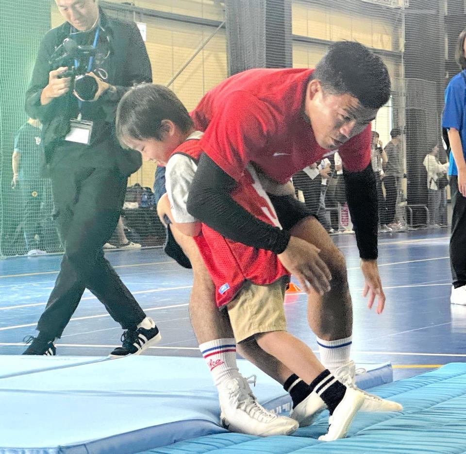 参加した子どものタックルを受ける文田