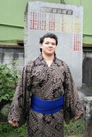師匠の武蔵川親方のしこ名、武蔵丸が刻まれた横綱石碑の前で撮影に応じる砂武蔵
