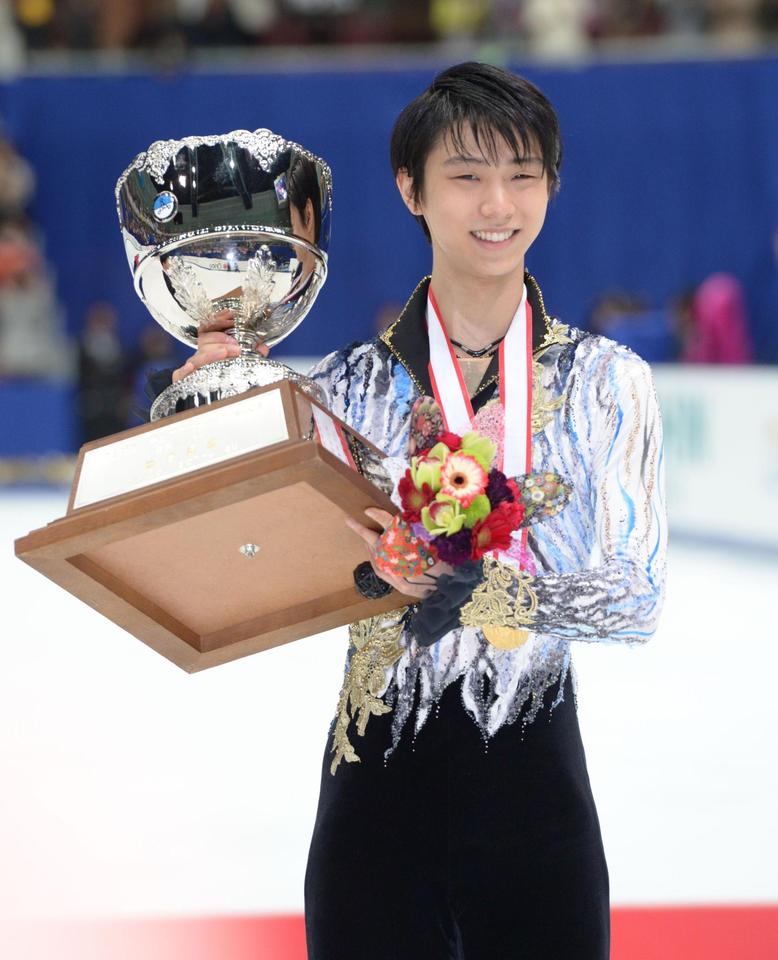 優勝カップを手に会心の笑みを浮かべる羽生結弦＝長野・ビッグハット（撮影・開出　牧）