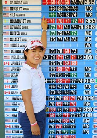 　通算５アンダーで米女子ゴルフツアー出場権を獲得し、笑顔で自身のスコアを指さす畑岡奈紗（共同）