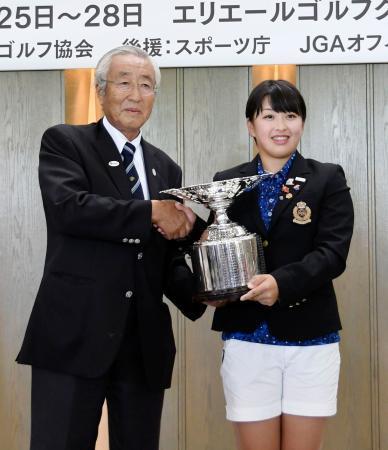 　初優勝し、表彰式で笑顔の西郷真央。左は日本ゴルフ協会の竹田恒正会長＝エリエールＧＣ松山