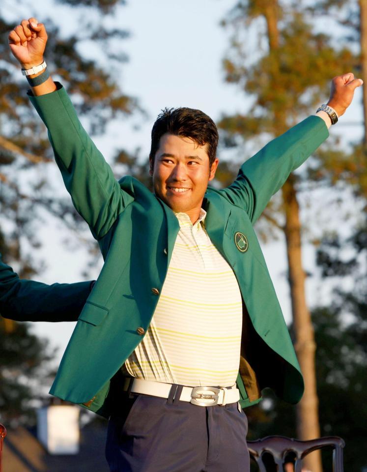 米ゴルフのマスターズ・トーナメントで、日本男子初のメジャー制覇を果たし、グリーンジャケットを着て両手を上げる松山英樹＝11日、米ジョージア州のオーガスタ・ナショナルＧＣ（ロイター＝共同）