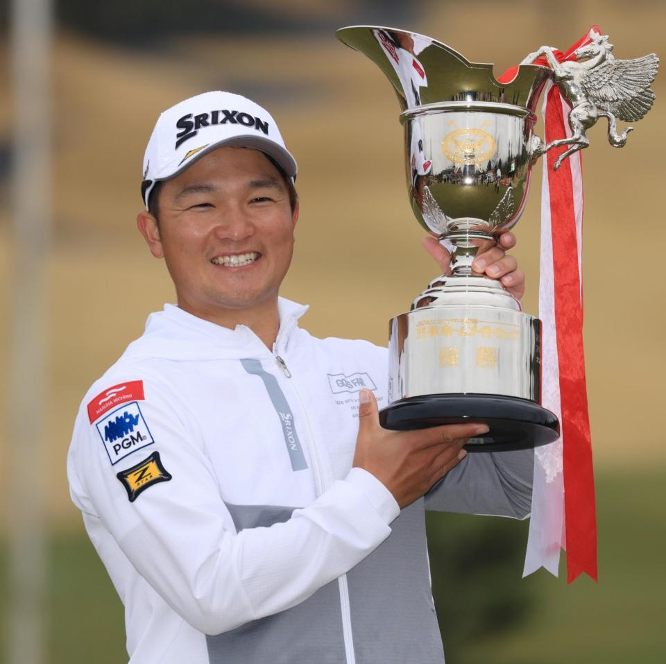 優勝カップを手に笑顔を見せる香妻