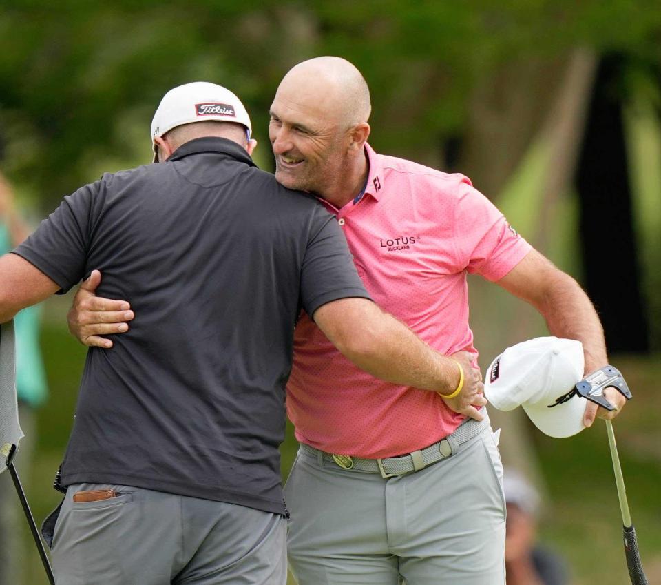 　優勝を決め、キャディーと抱き合って喜ぶマイケル・ヘンドリー（右）