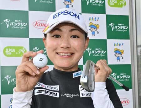 　１３番でホールインワンを決め、使用クラブと記念球を手に笑顔を見せる横峯さくら