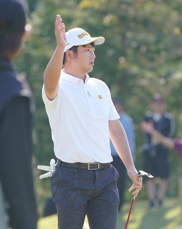 　１７番、バーディーパットを沈めギャラリーの歓声に応える小西たかのり（撮影・開出牧）