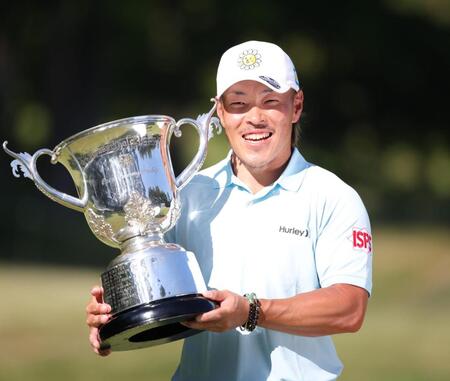 優勝カップを手に笑顔を見せる藤本佳則（撮影・坂部計介）