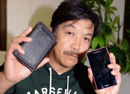 　マジック財布と代替機のスマートフォンを手に再起を誓うビッグダディこと林下清志＝都内（撮影・開出　牧）