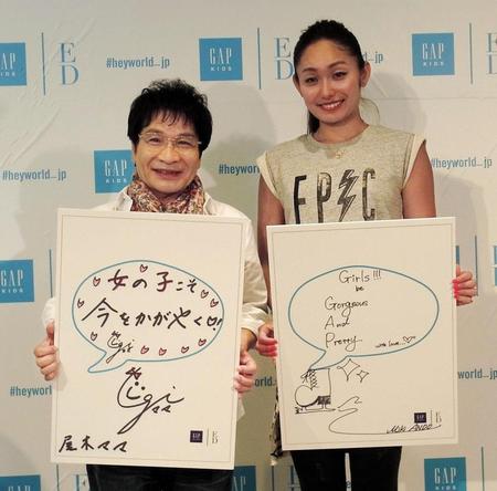 女の子に向けたメッセージボードを持つ尾木直樹（左）と安藤美姫＝東京・原宿