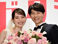 花輪を持ち笑顔を見せる井桁弘恵（左）と細田善彦＝東京・赤坂プリンスクラシックハウス（撮影・西岡正）