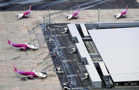 　一部施設の運用が再開した関西空港で、駐機するピーチ・アビエーションの機体（共同通信社ヘリから）