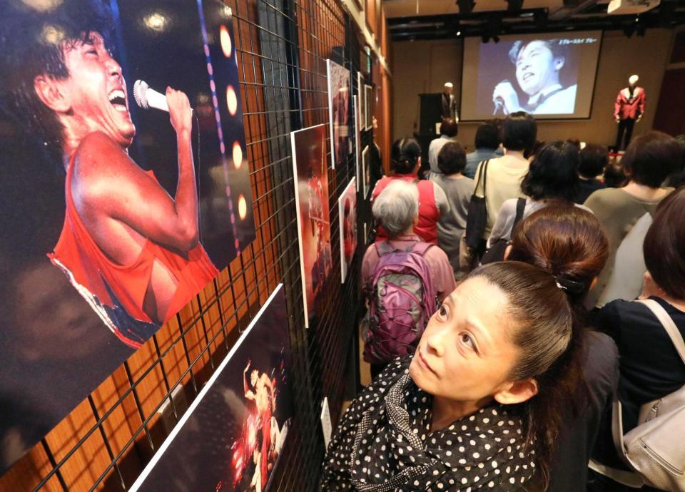 　西城秀樹さんの写真パネルやミュージックビデオを見る来場者＝東京・銀座