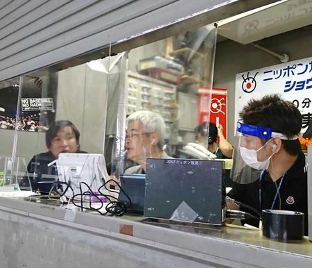 東京ドームの放送ブースにはアナウンサーと解説者の前に透明アクリル板が設置された。左は里崎智也氏、中央は煙山光紀アナ＝６月２日　