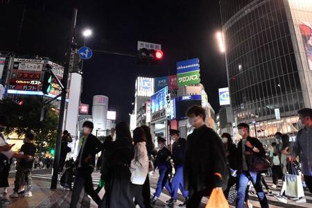 　大型ビジョンなどが消灯された渋谷駅前のスクランブル交差点を行き交う人たち（撮影・園田高夫）
