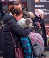 　ウクライナ・キエフ近郊イルピンで、別れを惜しんで抱き合う人々＝９日（ＵＰＩ＝共同）