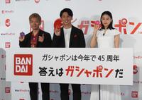 　カプセルを手に笑顔の（左から）嶋佐和也、屋敷裕政、山本美月＝東京都内