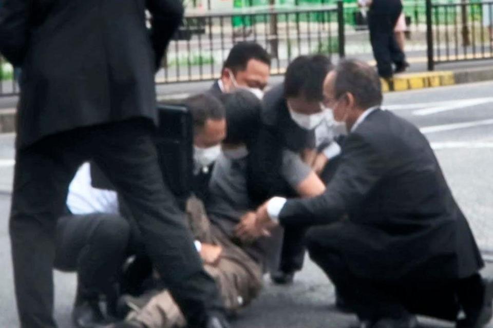 　安倍元首相が銃撃された現場付近で取り押さえられる男（中央）＝８日午前、奈良市