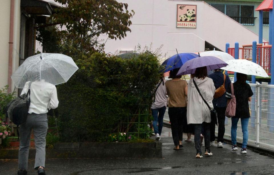 川崎幼稚園が開いた説明会に向かう保護者ら＝７日午前、静岡県牧之原市