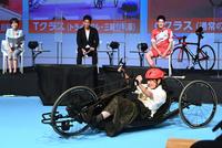 　武井壮（後列中央）らが見守る中、パラスポーツ用の手こぎ自転車に挑戦する渡邉美穂（撮影・高石航平）