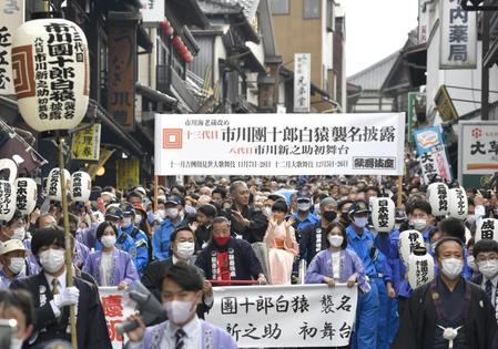 　御練り行列で人力車の上から手を振る（左から）堀越勸玄くん、市川海老蔵、市川ぼたん