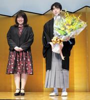 　妹弟子の中澤沙耶女流二段（左）から花束を受け取った藤井聡太王位＝都内