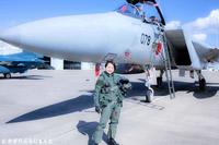 　Ｆ－１５の前で笑顔のかざり（「Ｇやばすぎて悲鳴！？　航空自衛隊の戦闘機Ｆ－１５に乗ります」から）