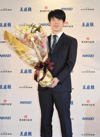 　八冠達成から一夜明け、会見で花束を受け取る藤井聡太新王座