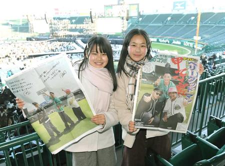 　デイリースポーツの特別号外を手にするファン