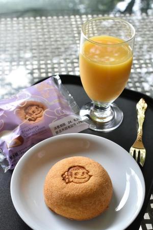 　藤井叡王のおやつ ペコちゃんのほっぺ（ブルーベリーチーズクリーム）とオレンジジュース（日本将棋連盟提供）