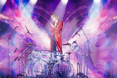 　ドラムセットの前でＸポーズを決めるＹＯＳＨＩＫＩ