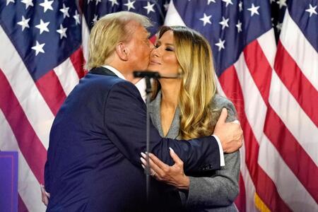 　米フロリダ州の集会会場で、妻のメラニアさん（右）とキスするトランプ前大統領＝６日（ＡＰ＝共同）