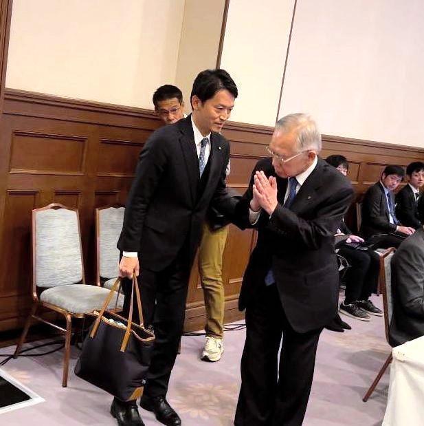 　謝罪後、斎藤元彦知事に着席を促され、手を合わせる谷口芳紀相生市長