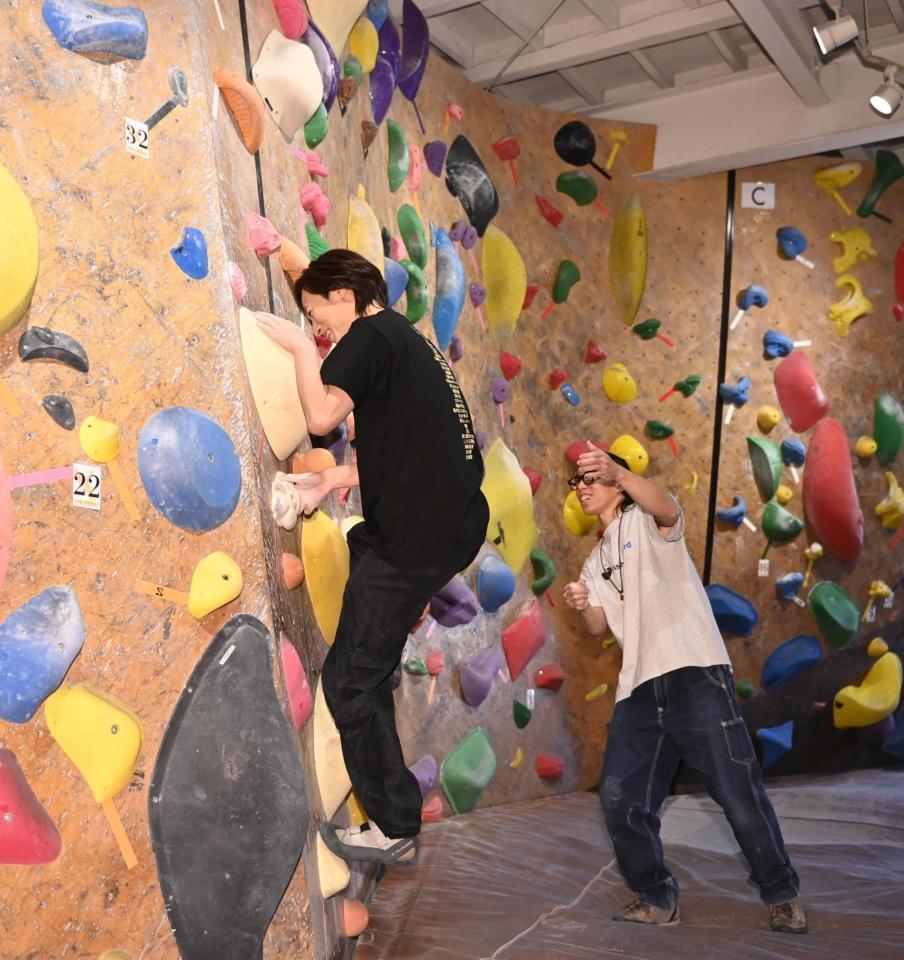 　インストラクターの鬼木哲也氏（右）の指導を受けながらボルダリングに挑戦する山内恵介（撮影・開出牧）