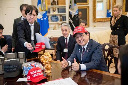 　ホワイトハウスで開かれたトランプ米大統領との会談でＭＡＧＡ帽子をかぶった赤沢経済再生相＝１６日（ホワイトハウス提供、共同）