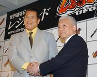 　格闘技イベントの会見で握手を交わす川村龍夫さん（右）とアントニオ猪木さん＝２００２年６月