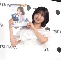 　写真集を笑顔でアピールする富田鈴花