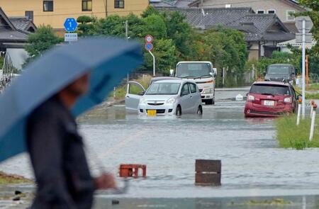 　大雨で冠水した熊本県玉名市の道路で水没した車