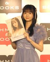 　写真集を持って写真に応じる江籠裕奈