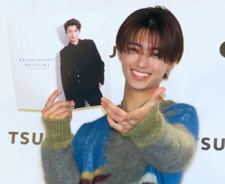 　カレンダーを手にポーズをとる鈴木秀脩