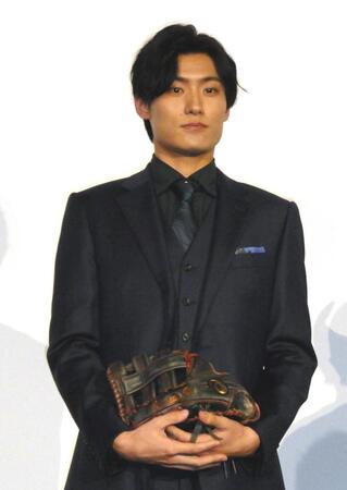 　横田慎太郎さんから譲り受けたグローブを持って登壇した松谷鷹也