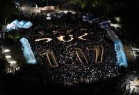 　阪神・淡路大震災から３１年となり、追悼会場に浮かび上がった「１９９５　つむぐ　１・１７」の文字